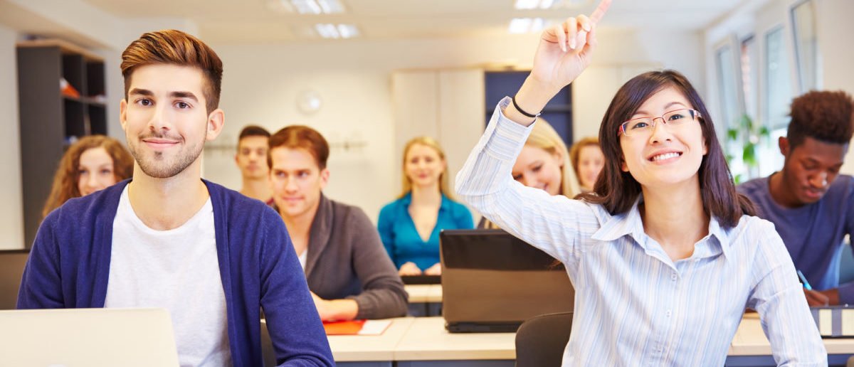 Asian-student-raising-her-hand-in-a-university-classroom-ShutterStock-Robert-Kneschke-e1526668325635.jpg